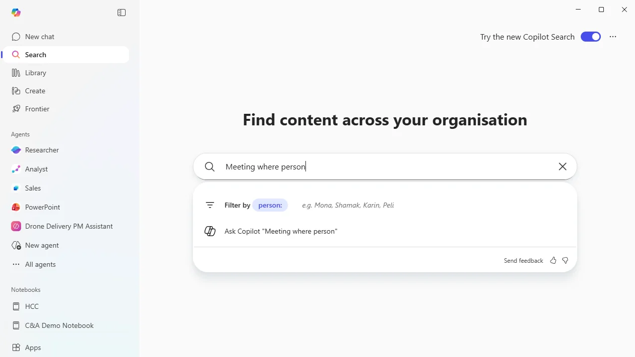 Copilot Search hero ('Find content across your organisation') with a partial query 'Meeting where person' triggering a real-time suggestion pill — 'Filter by person:' with example names Mona, Shamak, Karin, Peli